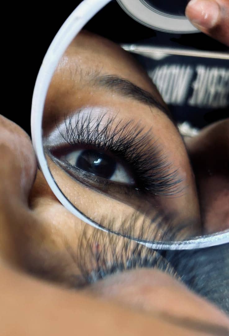 A finished lash set at Nallo, shown in a hand mirror